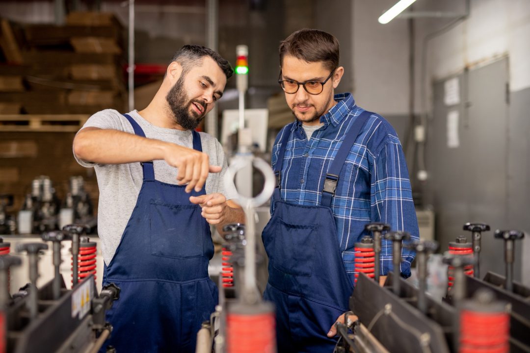 young engineer explaining his trainee how to serve and use technical equipment.jpg